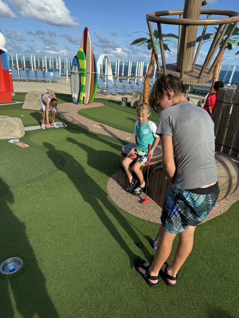 Playing mini golf on the sports deck of Freedom of the Seas