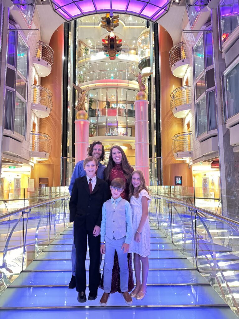 Our family dressed up for formal night on the atrium stairs of Royal Caribbean Freedom of the Seas