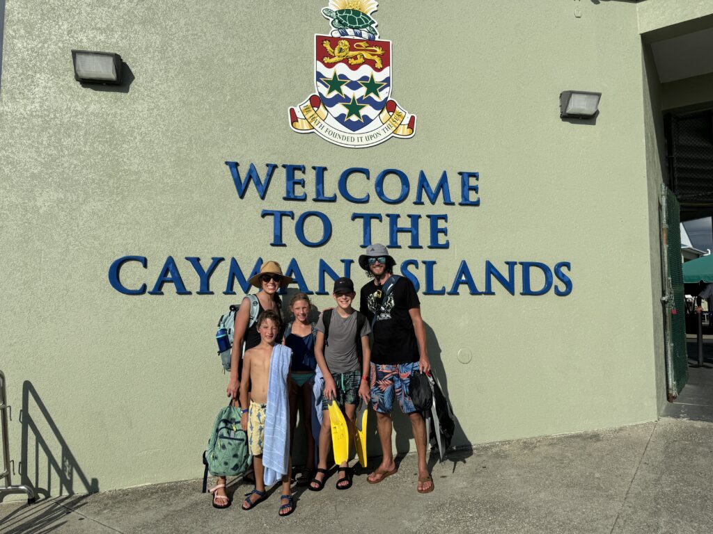 Our family at the Welcome to the Cayman Islands sign at the Grand Cayman cruise port