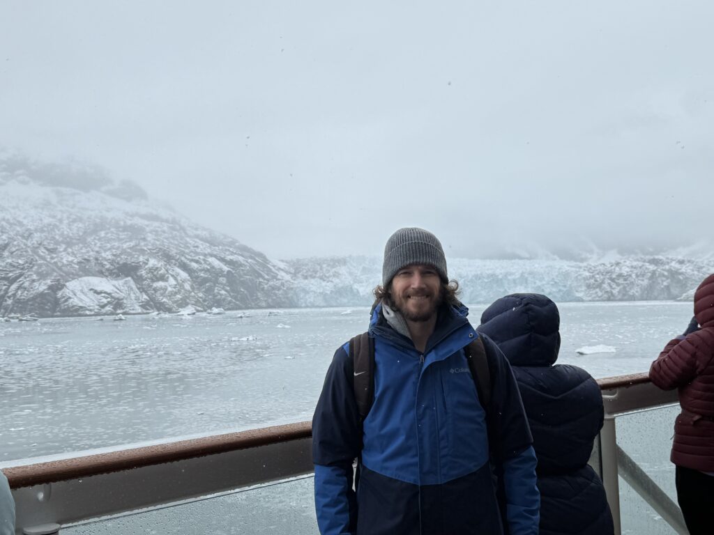 Bundled up on deck in front of a glacier in Glacier Bay, Alaska