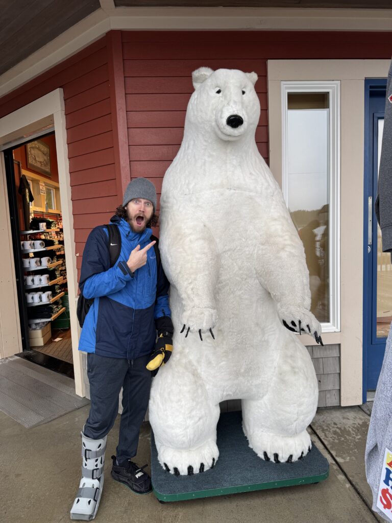 Posing with a giant polar bear statue outside a shop in Ketchikan
